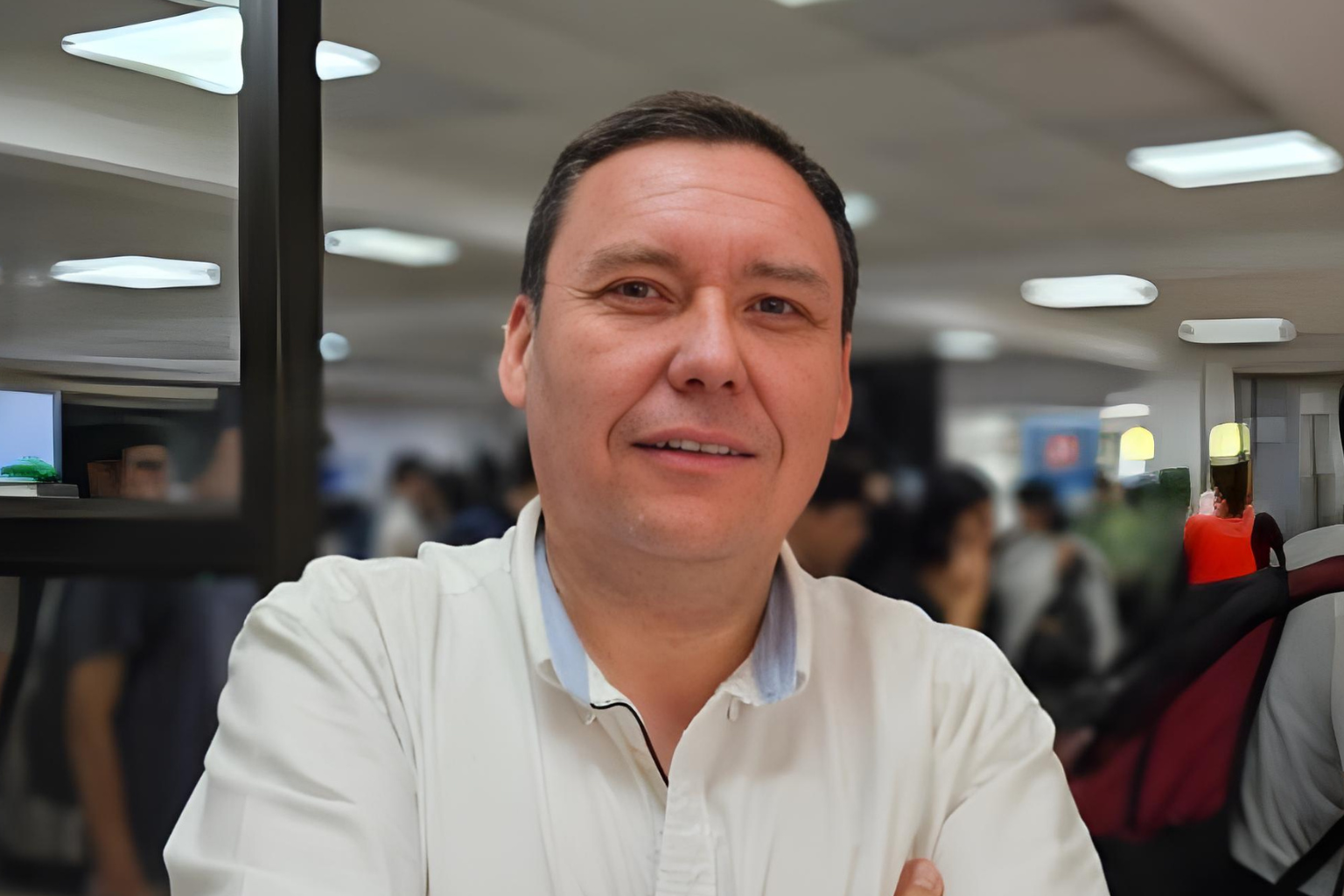 Marcelo Muñoz en primer plano, con camisa blanca, en un entorno corporativo, representando liderazgo y experiencia multigeneracional.