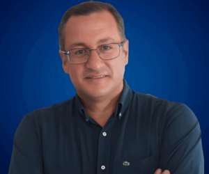 Fotografía de Felipe Peña y Lillo, conferencista profesional, posando con una expresión amigable y segura frente a un fondo azul.